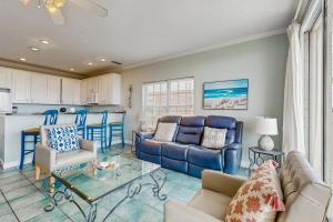 a living room with a couch and a table at Beach Joy - DIBC 206A in Dauphin Island