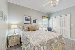 a bedroom with a bed and a ceiling fan at Beach Joy - DIBC 206A in Dauphin Island +28 photos