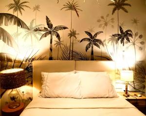 una camera da letto con un letto e un murale di palme di Casa Arcanjo - Patacho a Pôrto de Pedras Altre 40 foto