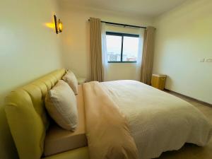 Ένα ή περισσότερα κρεβάτια σε δωμάτιο στο Cosy 2 bedroom APT in KILELESHWA