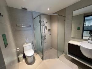 a bathroom with a shower and a toilet and a sink at Emerald Terrace Condo 3-Studio Garden Gem in Patong Beach +11 photos