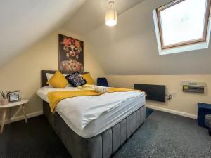 a bedroom with a large bed in a attic at Sherry's 2 Bed Guest House in Buckinghamshire