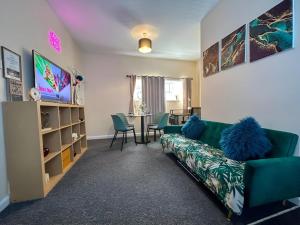 a living room with a couch and a table at Sherry's 2 Bed Guest House in Buckinghamshire