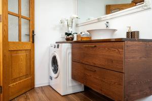 a laundry room with a sink and a washing machine at Sunny Lodging in Sliema