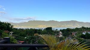 a view of a body of water with mountains at Residencial Azul Marinho - Suítes por temporada in Ilhabela