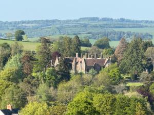 an old house in the middle of a forest at The Bus On The Hill in Huntsham