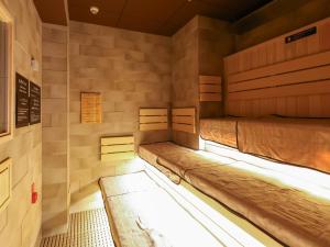 two bunk beds in a room with lights on at Dormy Inn Sapporo Annex in Sapporo