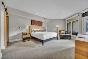 a large bedroom with a bed and a couch at Main St Gem Luxe 3BR with Hot Tub & Views in Park City