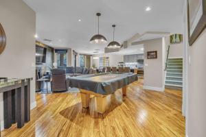 a living room with a table in the middle of a room at Main St Gem Luxe 3BR with Hot Tub & Views in Park City