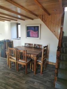 a dining room with a wooden table and chairs at Beacon View, Church Cross, Skibbereen, County Cork in Church Cross