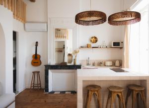 a kitchen with a counter and stools in a room at Villa Réal in Saint-Seurin-de-Cadourne