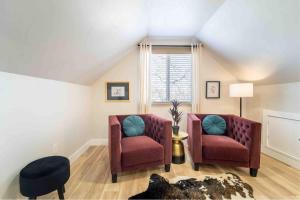 a living room with two chairs and a window at Morrison Getaway - 2BR House BBQ Free Parking in Morrison