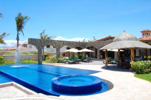 a swimming pool with a fountain in a yard at Villa Estero by Cabo Villas in San José del Cabo
