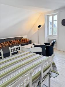 a bedroom with a bed and a living room at La maison Hortensias Vic-Sur-Cère - 6pers in Vic-sur-Cère