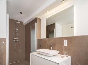 een badkamer met wastafel en douche bij Moderne stilvolle Wohnung im Herzen Münchens in München