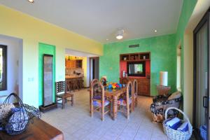 a living room with a table and a dining room at Villa Langosta by Cabo Villas in La Paz