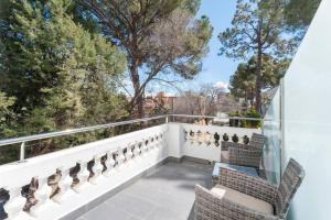 a balcony with chairs and a view of trees at 1893 Hotel Boutique in Navajas