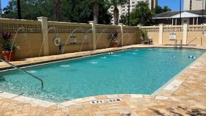 a swimming pool with blue water in front of a fence at Crowne Plaza Orlando-Downtown by IHG in Orlando