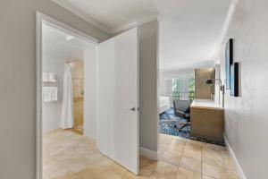 a hallway with a bathroom with a desk and a sink at Crowne Plaza Orlando-Downtown by IHG in Orlando