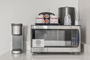 a microwave sitting on a counter next to a coffee maker at Crowne Plaza Orlando-Downtown by IHG in Orlando