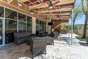 an outdoor patio with benches and tables and windows at Crowne Plaza Orlando-Downtown by IHG in Orlando