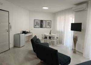a living room with a couch and a table at Il Triangolo in Termoli +17 photos