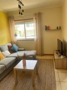 a living room with a couch and a table at Sea and Nature Escape in Furadouro