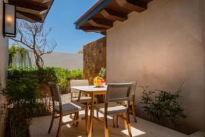 a table and chairs sitting on a patio at West Enclave 7 by Cabo Villas in San José del Cabo