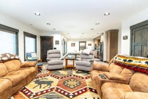 a living room with a couch and two chairs and a table at Henrys Lake Walkout Cabin in Staley Springs