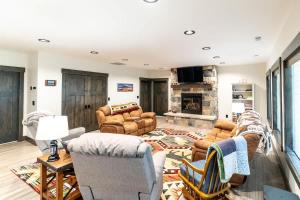 a living room with couches and a fireplace at Henrys Lake Walkout Cabin in Staley Springs