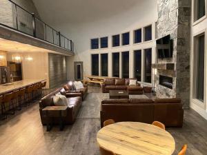 a large living room with couches and a bar at Dual Cabin- Yellowstone Family Retreat- Sled Hill in Ashton +44 photos