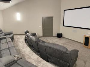 a living room with a couch and a projection screen at Dual Cabin- Yellowstone Family Retreat- Sled Hill in Ashton