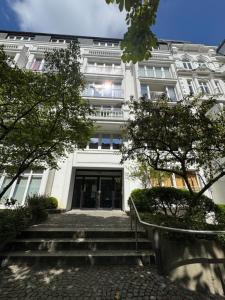 a large white building with stairs in front of it at City Residence H14 - Prime location - perfect for Business & Lifestyle in Hamburg