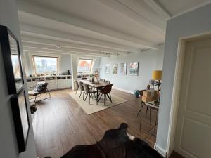 a dining room and living room with a table and chairs at City Residence H14 - Prime location - perfect for Business & Lifestyle in Hamburg +5 photos
