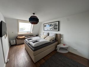 a bedroom with a bed and a couch in a room at City Residence H14 - Prime location - perfect for Business & Lifestyle in Hamburg