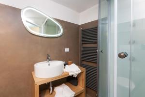 a bathroom with a sink and a mirror at San Matteo House in Lecce +20 photos