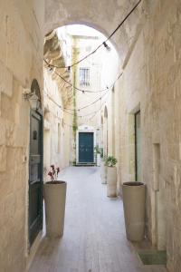 an alley with potted plants in a building at San Matteo House in Lecce
