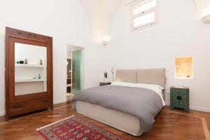 a bedroom with a large bed and a mirror at San Matteo House in Lecce