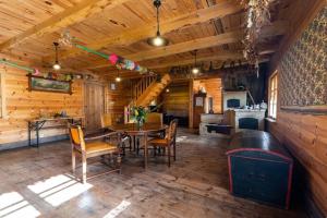 a dining room with a table and chairs in a cabin at Holiday Home in Be czna near Kl pnicko Lake in Bełzcna
