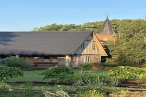 a large wooden house with a gambrel roof at Holiday Home in Be czna near Lake Kl pnicko in Bełzcna
