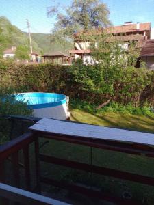 a table on a balcony with a swimming pool at Riverlyn Guest House in Ribarica