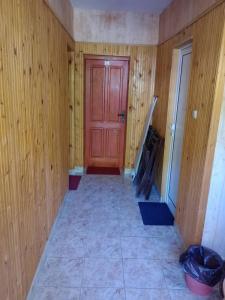 a room with a red door and a tile floor at Riverlyn Guest House in Ribarica