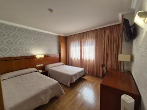 Posteľ alebo postele v izbe v ubytovaní Hotel HHB Pontevedra Confort