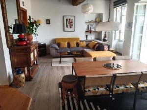 a living room with a couch and a table at Maison Haute in Moux-en-Morvan