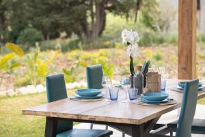 a wooden table with blue dishes and flowers on it at Villa Manù country house in Castellammare del Golfo +31 photos