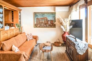 a living room with a couch and a table at Nisaki House in Skiathos