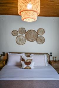 a bedroom with a bed with plates on the wall at Nisaki House in Skiathos