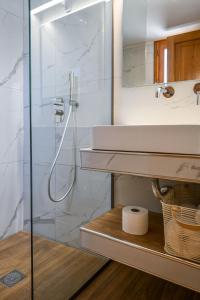 a bathroom with a sink and a shower at Nisaki House in Skiathos +38 photos