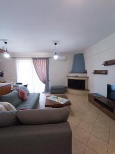 una sala de estar con un sofá y una mesa en Marys Homes, en Lefkada