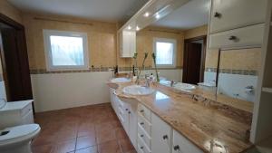 a bathroom with three sinks and a toilet at Rooms Flor del Pato in Benalmádena +47 photos